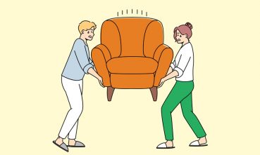 une femme et un homme déplaçant un fauteuil